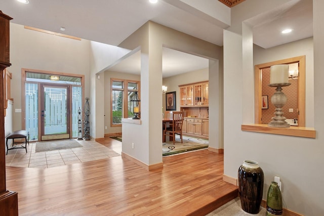 entrance foyer featuring recessed lighting, light wood-style flooring, and baseboards