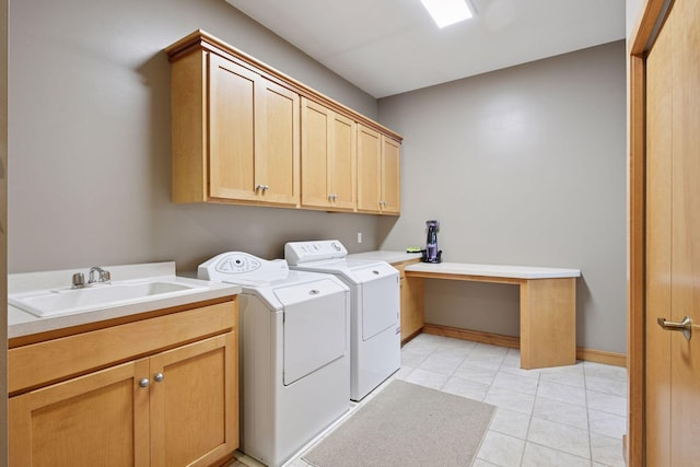 laundry area featuring cabinet space, light tile patterned flooring, a sink, and washer and dryer