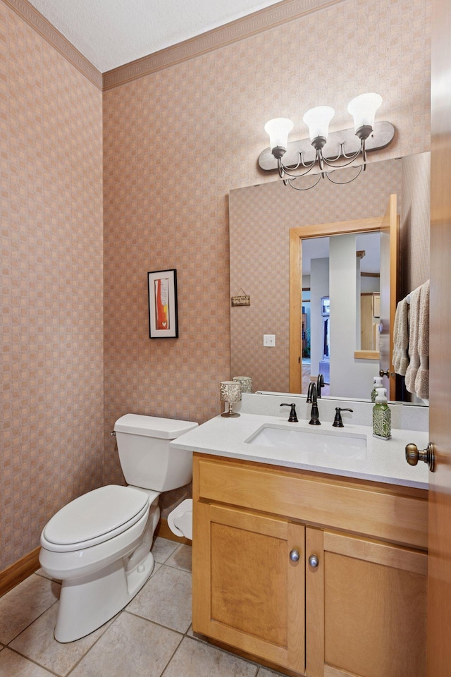 bathroom with vanity, tile patterned flooring, ornamental molding, and toilet
