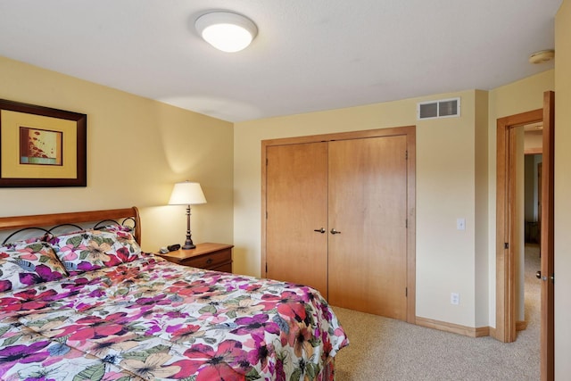 carpeted bedroom with baseboards, visible vents, and a closet