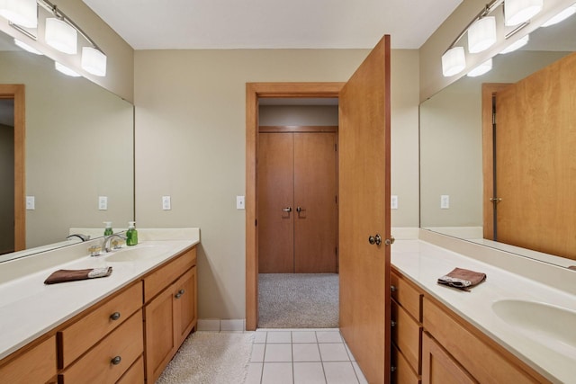 full bath with vanity, baseboards, and tile patterned floors