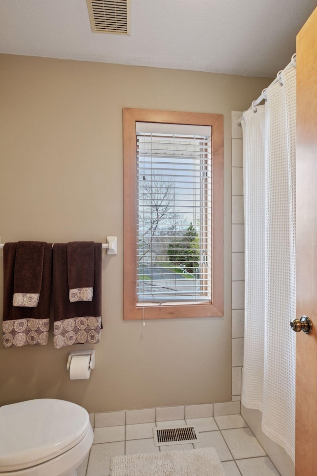 bathroom featuring tile patterned flooring, toilet, and visible vents