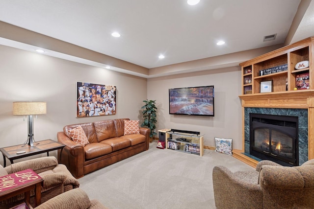living area with carpet flooring, a premium fireplace, recessed lighting, baseboards, and visible vents