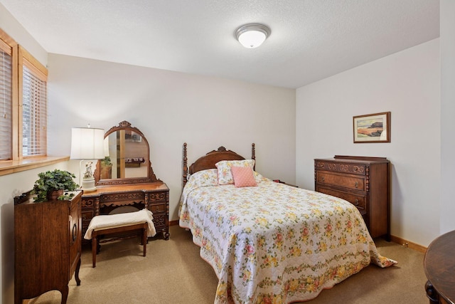 carpeted bedroom featuring baseboards