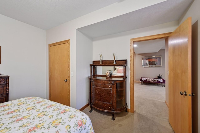 carpeted bedroom featuring baseboards