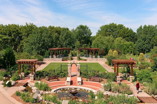 view of community with a lawn and a pergola