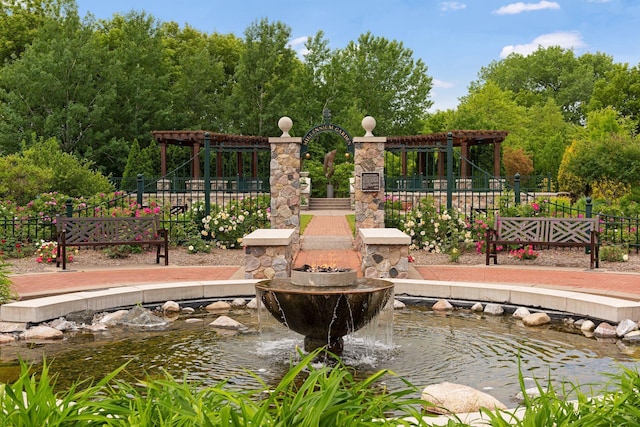 exterior space featuring a small pond and fence