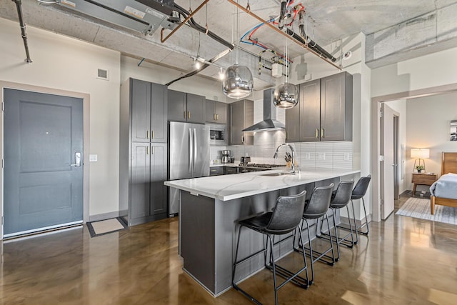 728 3rd St N Unit 705, Minneapolis, MN 55401 - kitchen with appliances with stainless steel finishes, wall chimney exhaust hood, finished concrete floors, and gray cabinets