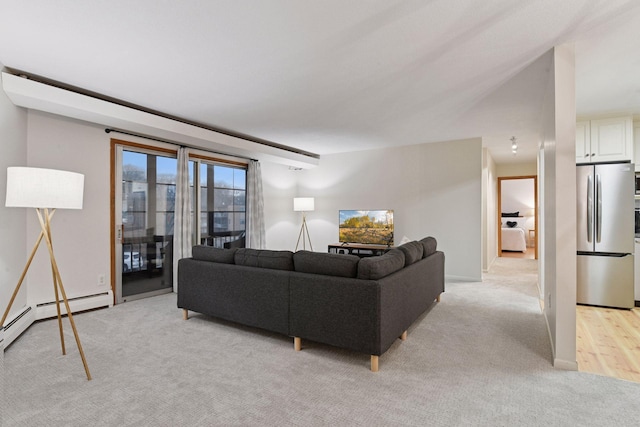 living room with a baseboard radiator and light carpet