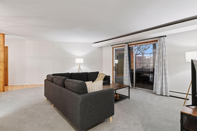 living area featuring a baseboard heating unit and light carpet