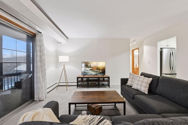 living room with baseboards, light carpet, and baseboard heating