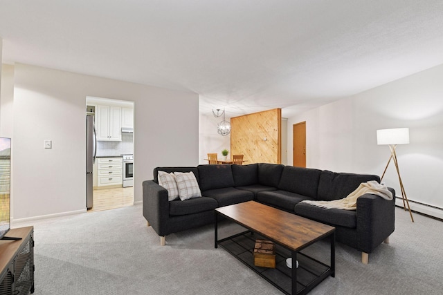 living room featuring baseboards, an inviting chandelier, light carpet, and a baseboard radiator