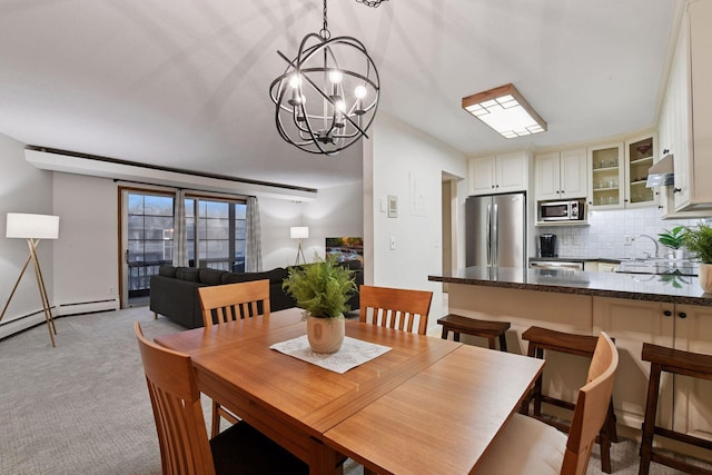 dining room featuring light carpet and a notable chandelier