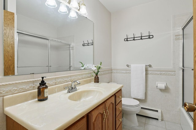 bathroom with baseboard heating, vanity, toilet, tile patterned floors, and a chandelier