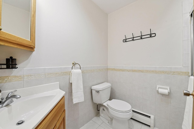 bathroom featuring tile walls, tile patterned flooring, a wainscoted wall, a baseboard heating unit, and toilet