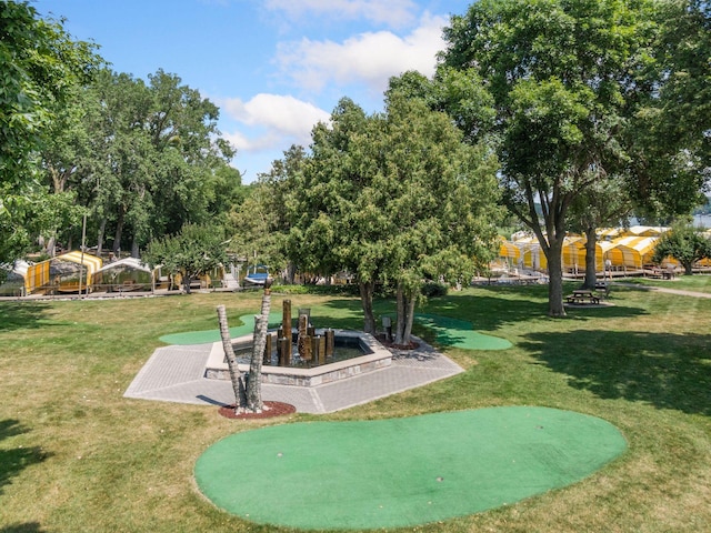 view of property's community with a lawn