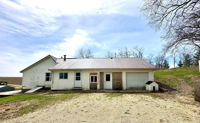 27227 Raven Rd, Spring Valley, MN 55975 - back of house with a garage, dirt driveway, and metal roof