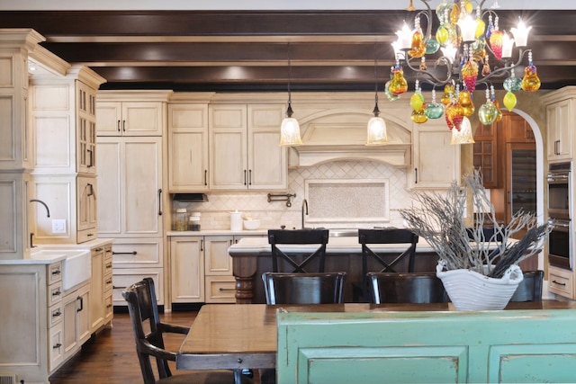 kitchen featuring dark wood-type flooring, light countertops, beamed ceiling, and tasteful backsplash