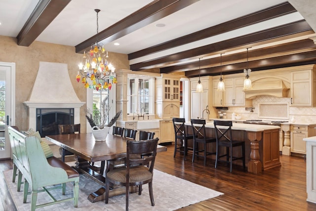 dining area with beamed ceiling, an inviting chandelier, dark wood-style floors, and a healthy amount of sunlight