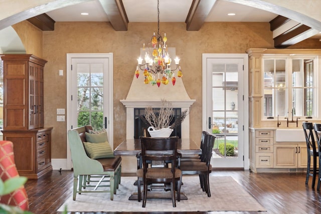 living area with beamed ceiling, arched walkways, dark wood finished floors, a notable chandelier, and a premium fireplace