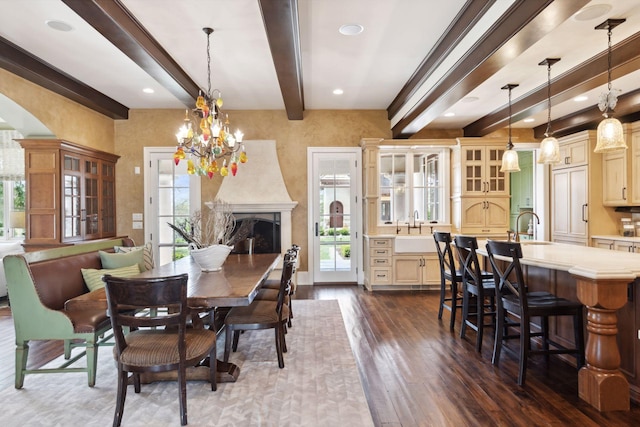 dining room featuring beam ceiling, a healthy amount of sunlight, and dark wood-type flooring