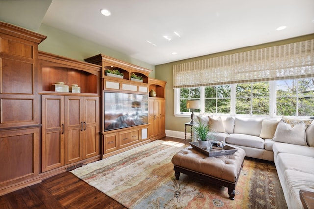 living area with recessed lighting, baseboards, and dark wood finished floors