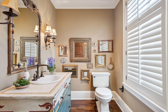 bathroom featuring baseboards, vanity, toilet, and wood finished floors