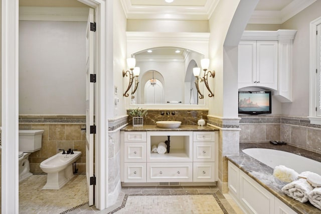 full bathroom featuring tile patterned flooring, ornamental molding, tile walls, a wainscoted wall, and a bidet