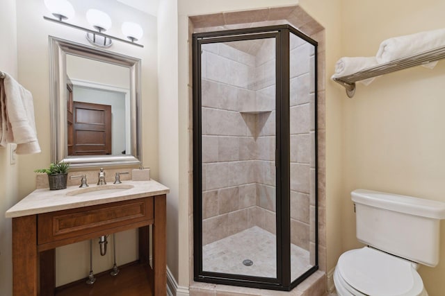 full bath with a sink, a stall shower, and toilet