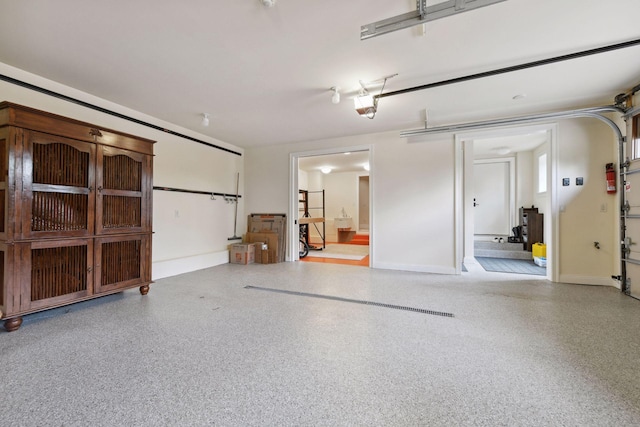 garage featuring baseboards and a garage door opener
