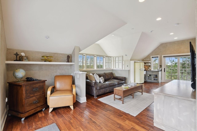 living room featuring recessed lighting, lofted ceiling, and wood finished floors