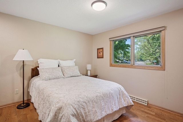220 Willow Ln, Foley, MN 56329 - bedroom featuring wood finished floors and baseboards