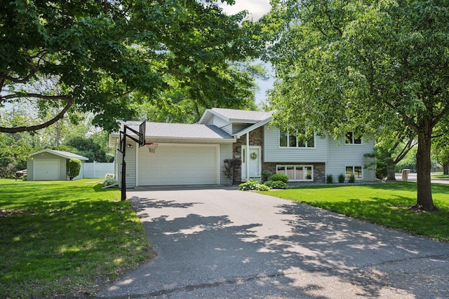 220 Willow Ln, Foley, MN 56329 - split level home featuring stone siding, a garage, and driveway
