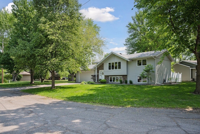 220 Willow Ln, Foley, MN 56329 - view of front of property featuring driveway, a front yard, and an attached garage