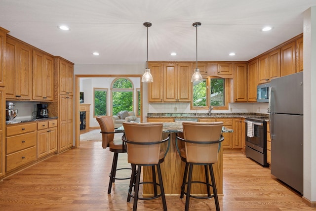 220 Willow Ln, Foley, MN 56329 - kitchen featuring stainless steel appliances, healthy amount of natural light, light wood-style flooring, and recessed lighting
