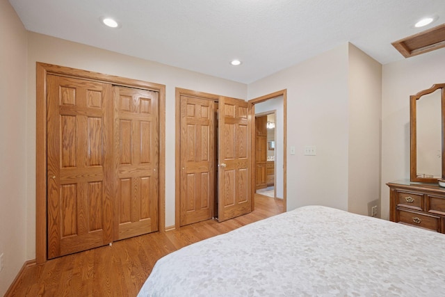 220 Willow Ln, Foley, MN 56329 - bedroom with multiple closets, light wood-type flooring, and recessed lighting