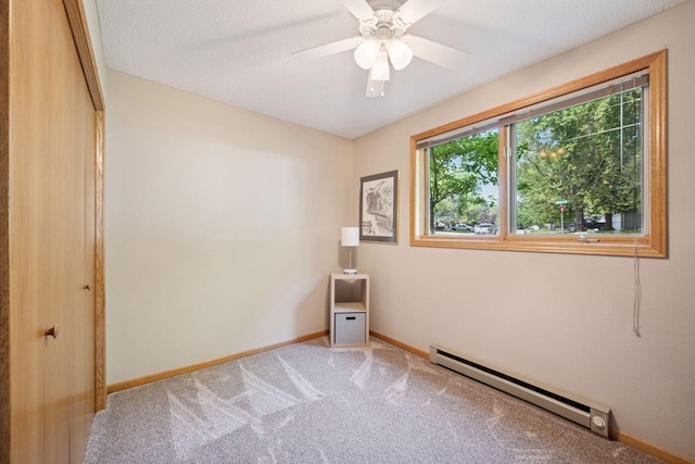 220 Willow Ln, Foley, MN 56329 - carpeted empty room with a baseboard heating unit and a ceiling fan