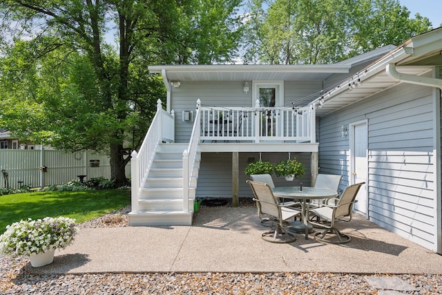 220 Willow Ln, Foley, MN 56329 - back of property featuring stairway, a patio area, a wooden deck, and outdoor dining area