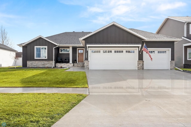 3682 Merrifield Dr S, Fargo, ND 58104 - view of front of home featuring board and batten siding, a garage, stone siding, driveway, and a front yard