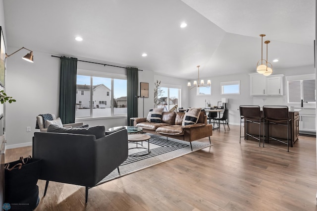 3682 Merrifield Dr S, Fargo, ND 58104 - living area with a chandelier, light wood finished floors, recessed lighting, vaulted ceiling, and baseboards