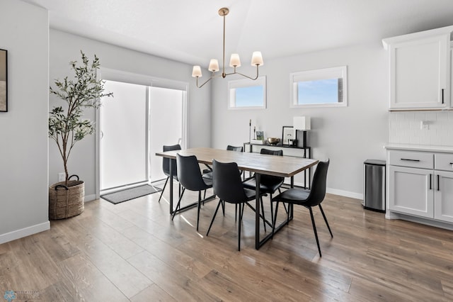 3682 Merrifield Dr S, Fargo, ND 58104 - dining area with wood finished floors, a chandelier, and baseboards