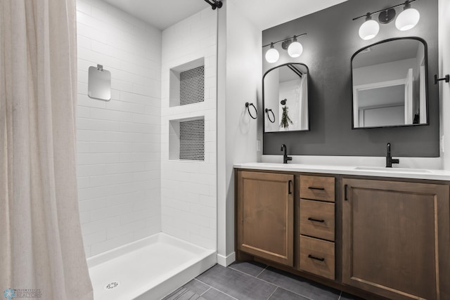 3682 Merrifield Dr S, Fargo, ND 58104 - full bath with tile patterned floors, double vanity, and tiled shower