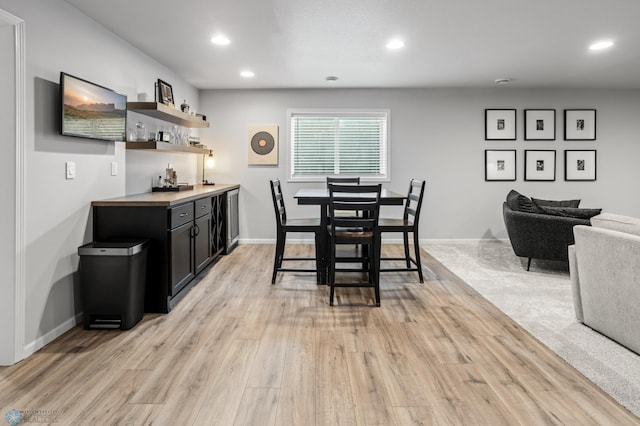3682 Merrifield Dr S, Fargo, ND 58104 - dining room featuring wet bar, recessed lighting, light wood-style flooring, and baseboards