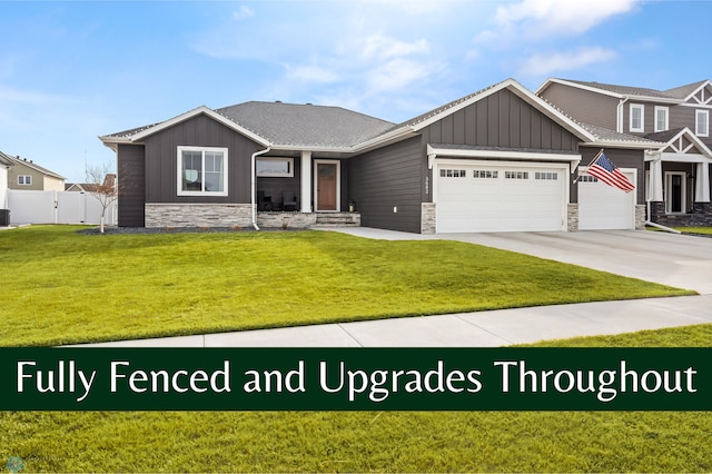 3682 Merrifield Dr S, Fargo, ND 58104 - view of front of house featuring board and batten siding, stone siding, an attached garage, and concrete driveway