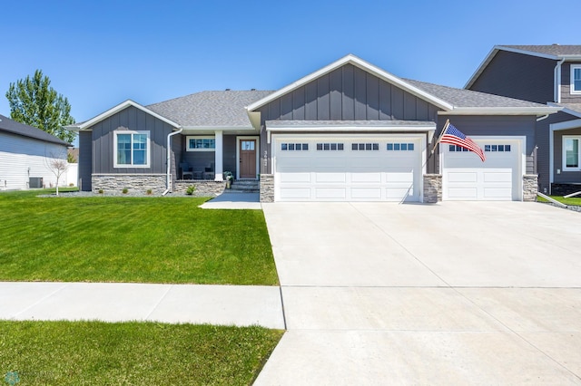 3682 Merrifield Dr S, Fargo, ND 58104 - craftsman house with board and batten siding, a garage, concrete driveway, a front lawn, and stone siding