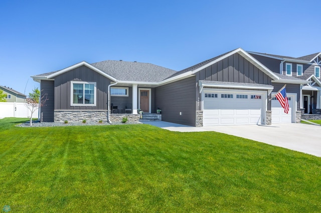 3682 Merrifield Dr S, Fargo, ND 58104 - view of front facade featuring board and batten siding, covered porch, a garage, driveway, and stone siding
