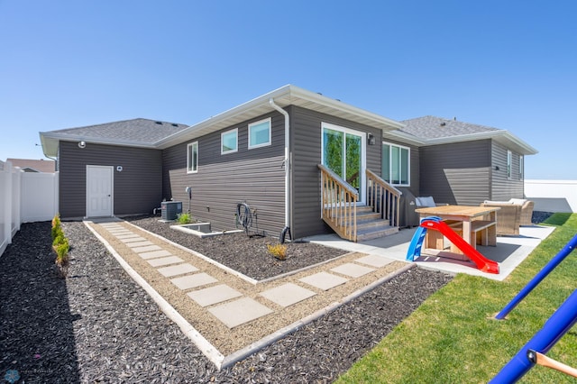 3682 Merrifield Dr S, Fargo, ND 58104 - rear view of house with entry steps, a patio, central air condition unit, and roof with shingles