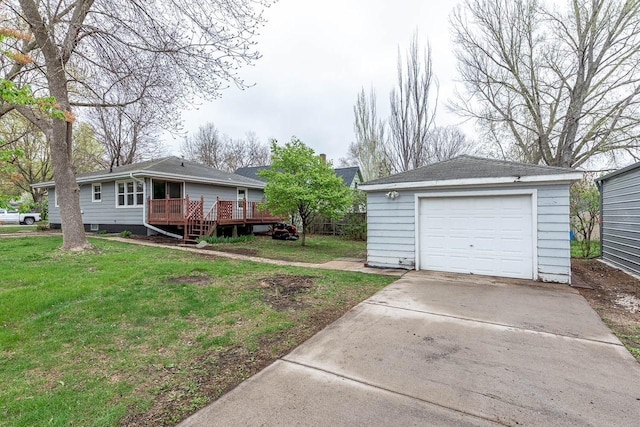 view of yard featuring a garage, driveway, an outbuilding, and a deck