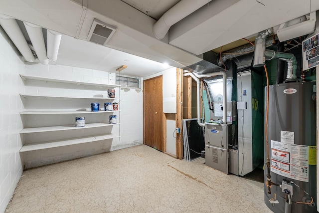 unfinished below grade area featuring heating unit, concrete block wall, and gas water heater