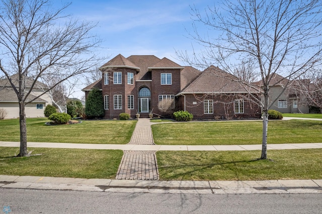view of front of property featuring brick siding and a front lawn